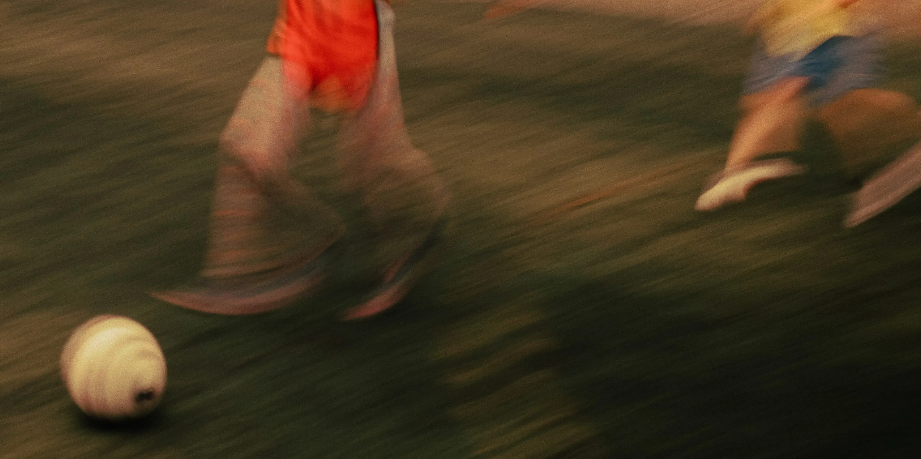 A photo of players kicking a football.